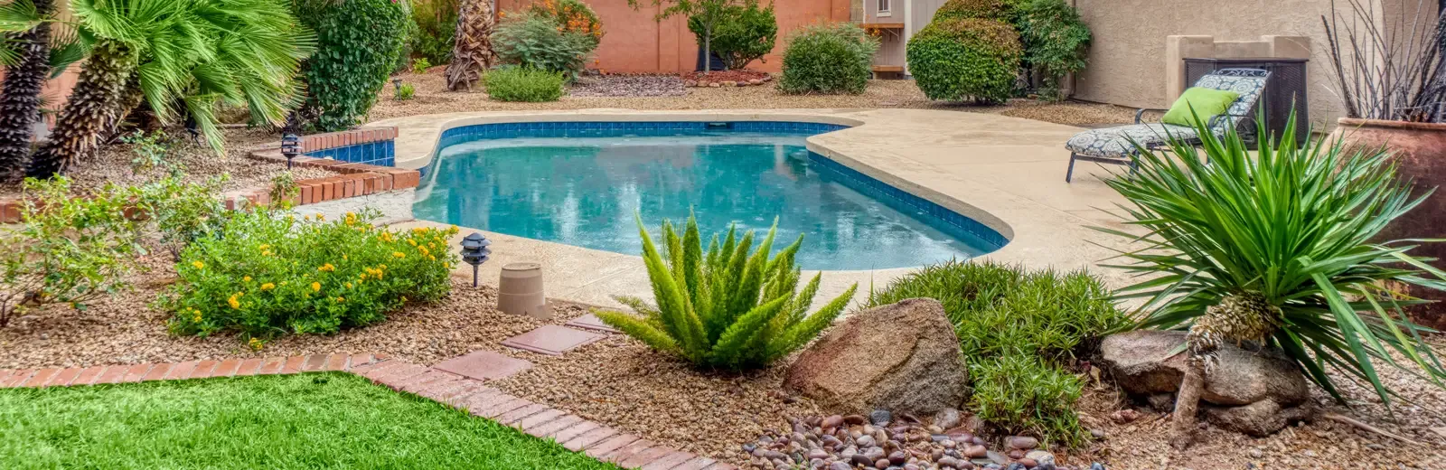 nicely landscaped back yard next to pool